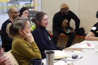 People watching a presentation and smiling. 