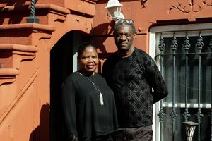 Homeowners in front of their door.