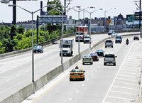 A highway with cars and trucks driving in both directions