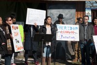 Group of advocates behind a podium speak out and hold signs calling attention to the pollution caused by traffic on the Sheridan Expressway