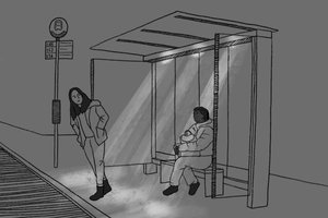 A bus stop at night, one woman stands at the curb looking for the bus, another sits on a bench holding her bag.