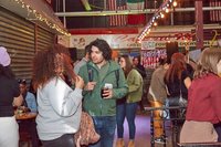 People mingling in a bright, festively decorated food hall.