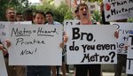 Two dozen young men and few other people waving a collection of handmade signs that read, “Metro=Hazard Privatize Now,” “Can’t PokeGo Metro Slow,” “The Metro is More Lit Than My Mixtape” and “Bro, do you even Metro?” as part of a protest in Dupont Circle in July 19, 2016.