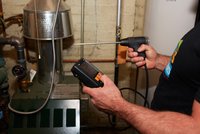 Man conducts safety tests on a boiler
