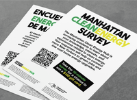 Two posters titled "Manhattan Clean Energy Survey" with QR codes and more information about the Manhattan Clean Energy Hub lay face up on a table.