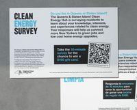 Two posters lay face up on a table. Entitled "Clean Energy Survey," one poster is in English and the other in Spanish. They request that people take a 10 minute survey.